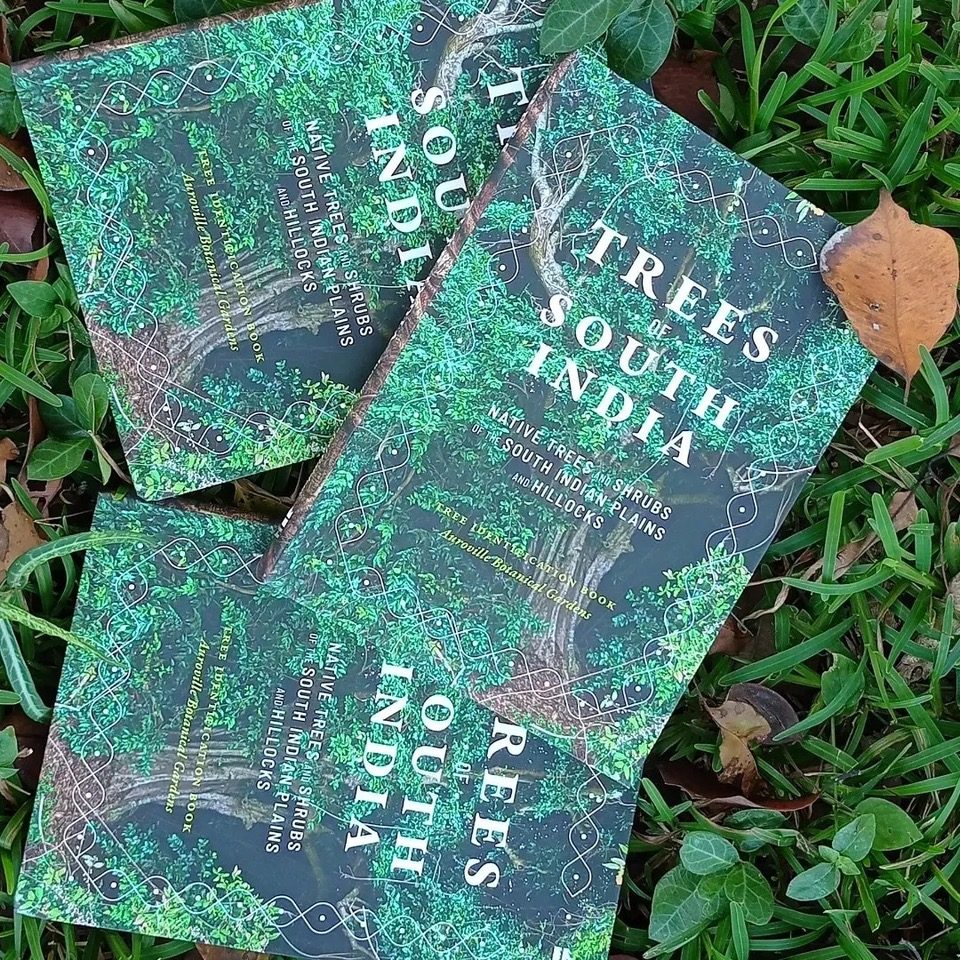 Copies of Trees of South India lying on grass, showing the green forest cover